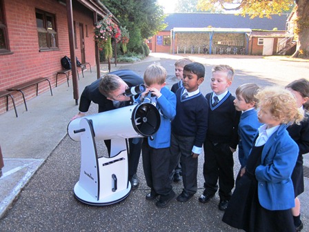 Mr Lutkins shows of new telescope to Year 1 pupils.